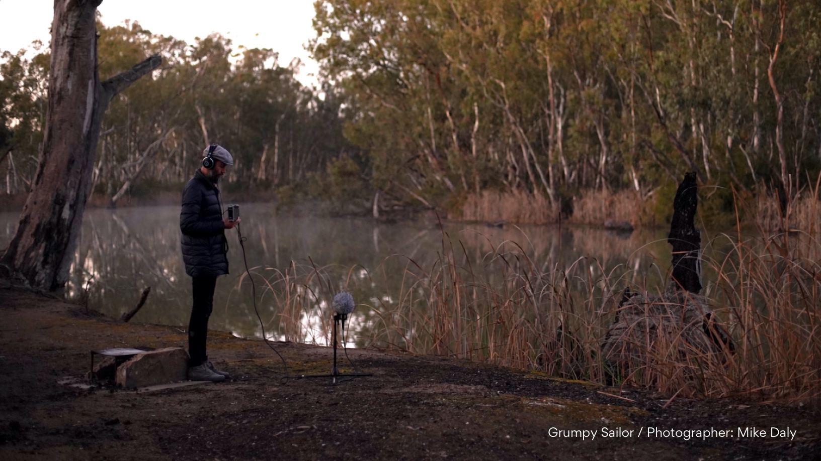 Man with audio recorder beside the Murray River.