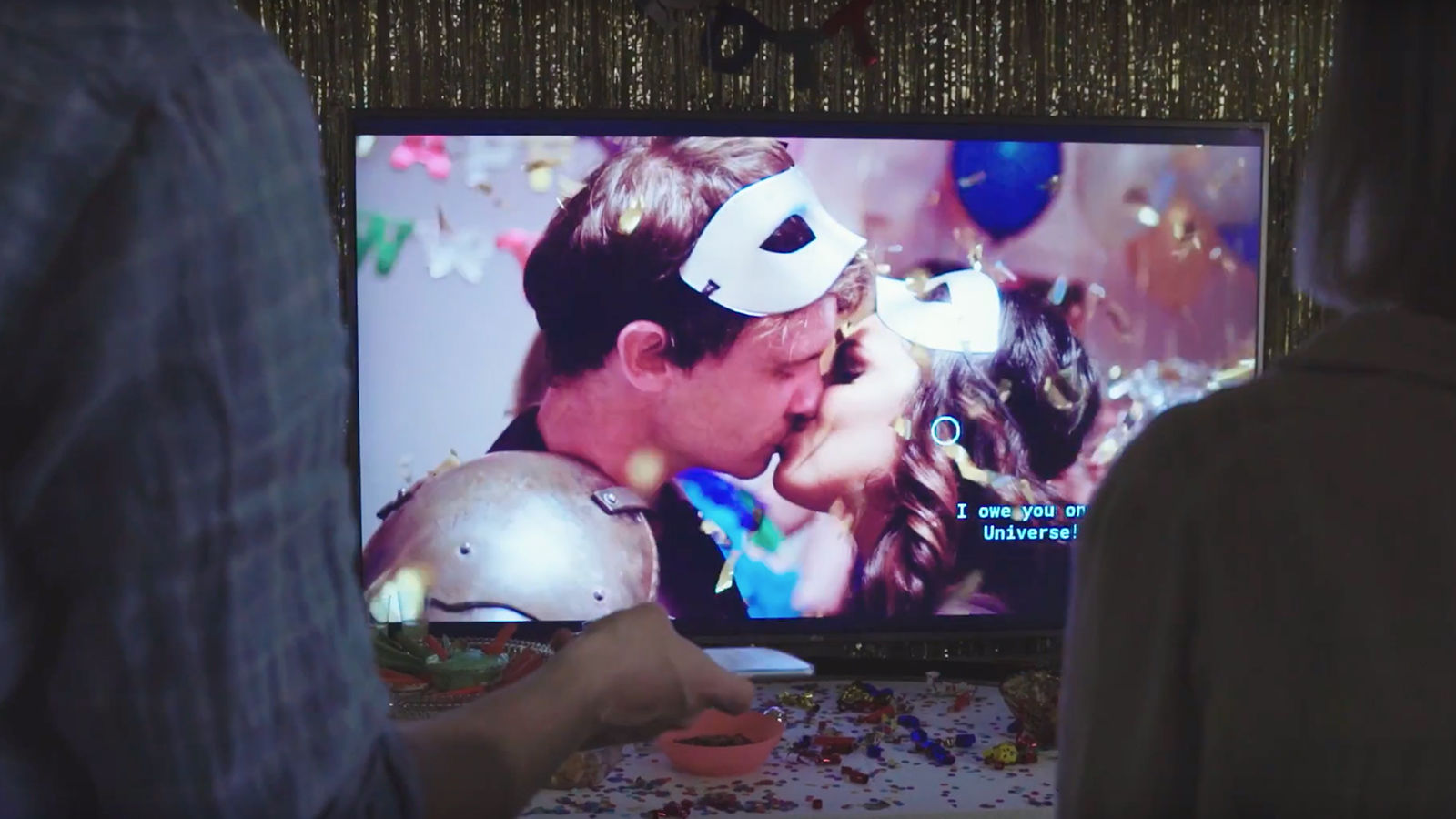 A couple kiss on screen.