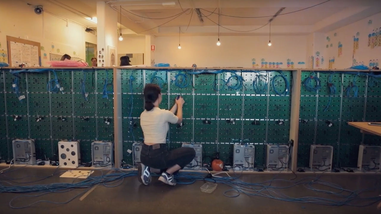 Woman wiring cables to the pixel interface.